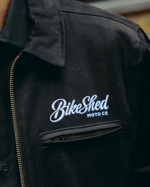 detail of the Bike Shed Moto logo on our black twill motorcycle jacket