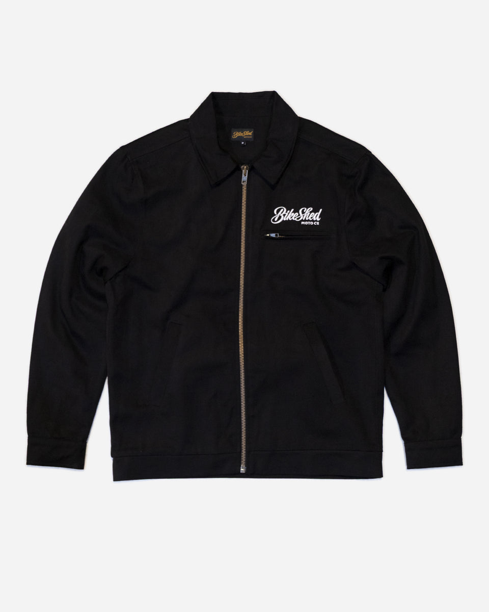 Black twill motorcycle jacket with a Bike Shed Moto Co brand logo on a white background