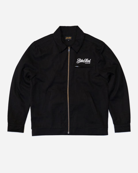Black twill motorcycle jacket with a Bike Shed Moto Co brand logo on a white background