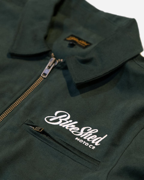 Green motorcycle jacket with 'Bike Shed Moto Co' logo on a white background